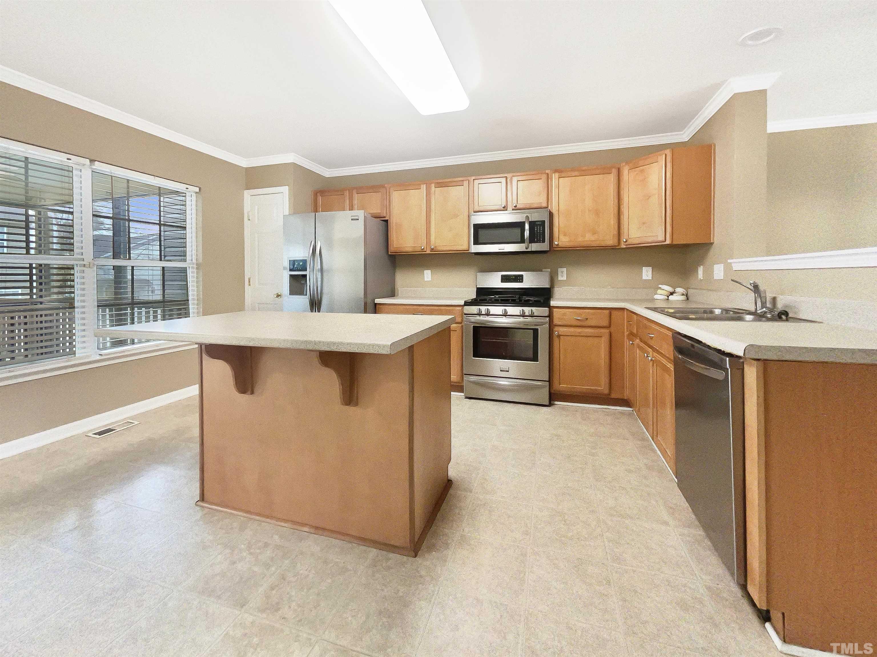 5115 Neuse Commons Lane Raleigh, NC 27616 - Photo 2 of 22 a large kitchen with stainless steel appliances granite countertop a stove top oven a sink dishwasher a dining table and chairs with wooden floor