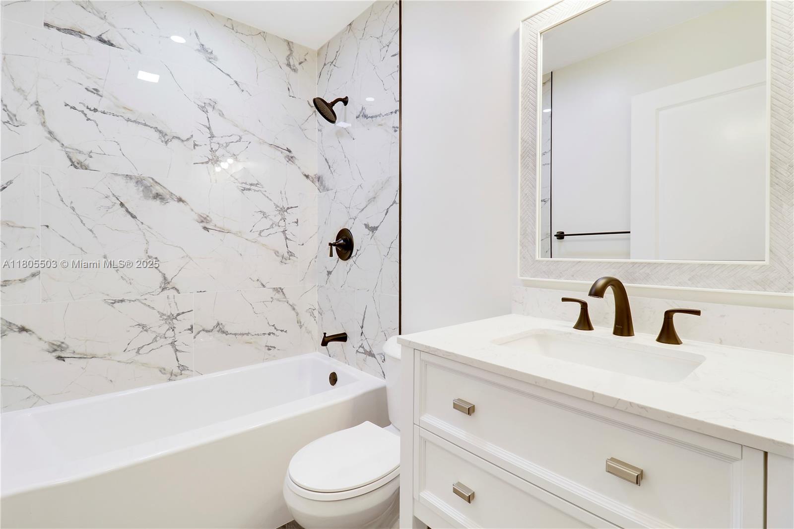 143 Greentree Circle Jupiter, FL 33458 - Photo 13 of 16 a bathroom with a sink a toilet and a bathtub