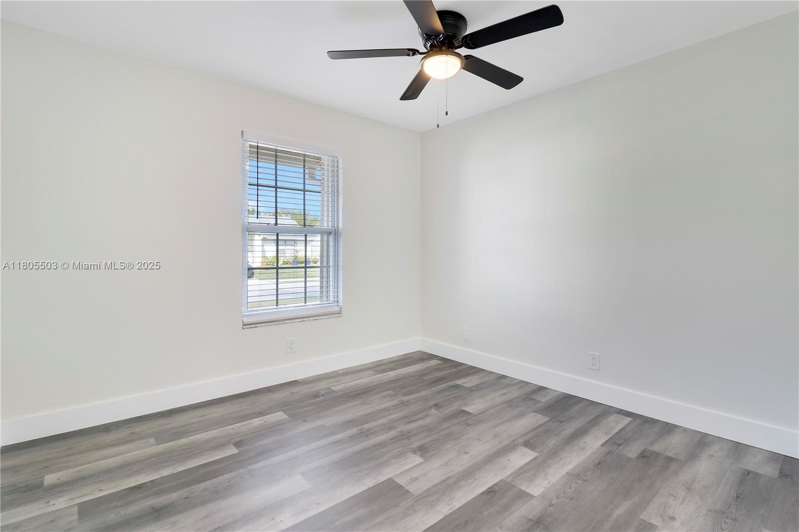 143 Greentree Circle Jupiter, FL 33458 - Photo 15 of 16 wooden floor in an empty room with a window