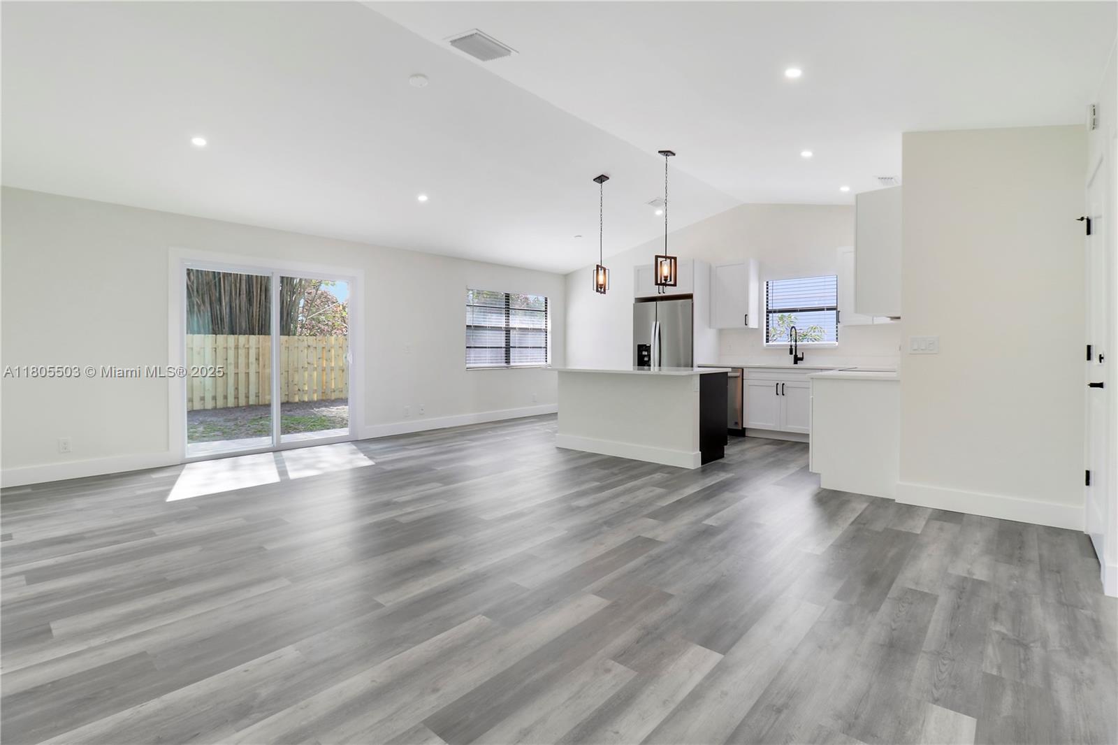 143 Greentree Circle Jupiter, FL 33458 - Photo 6 of 16 a view of kitchen with cabinets and wooden floor