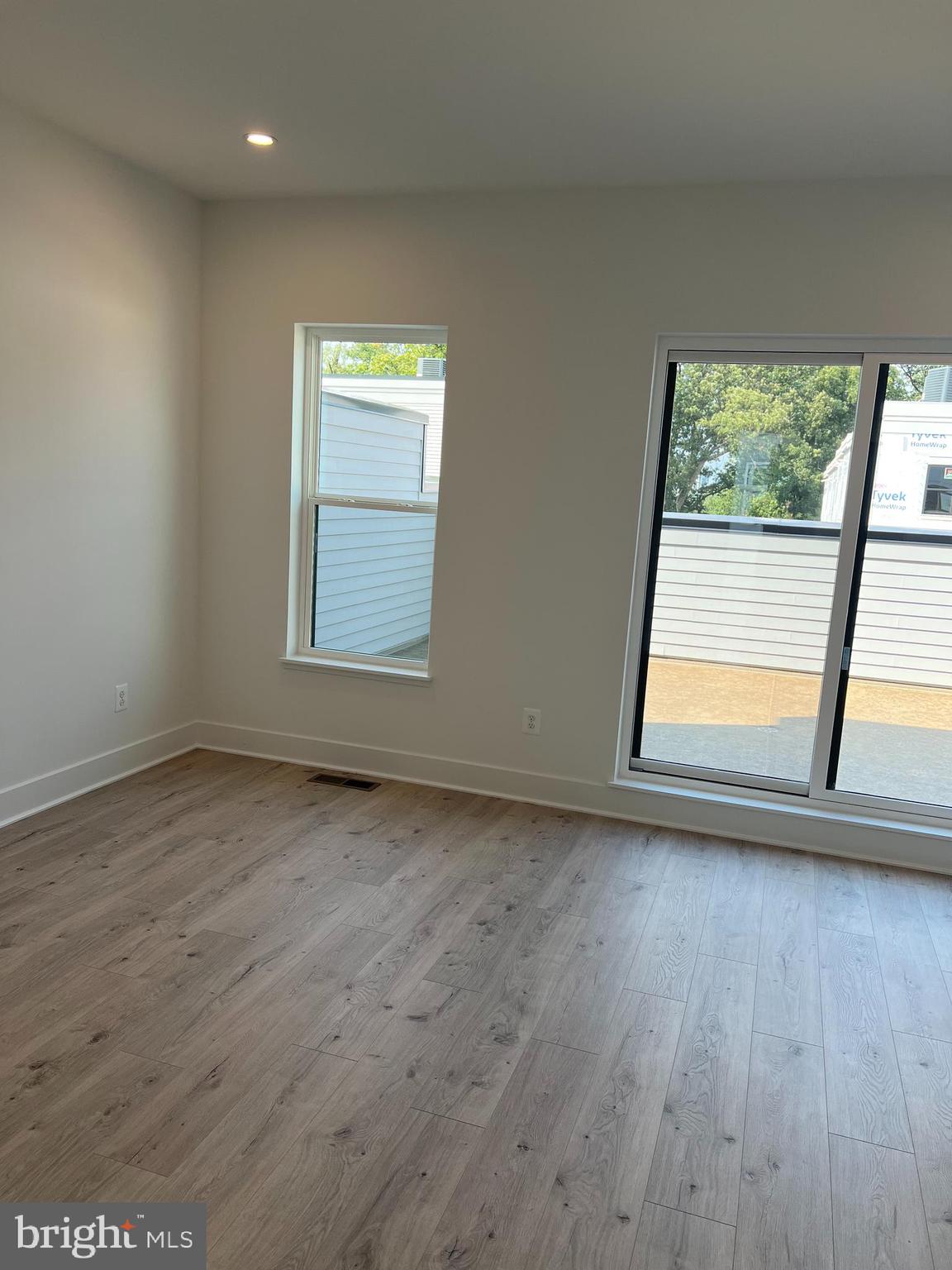 2139 Tysons Ridgeline Road Falls Church, VA 22043 - Photo 15 of 25 a view of an empty room with wooden floor and a window