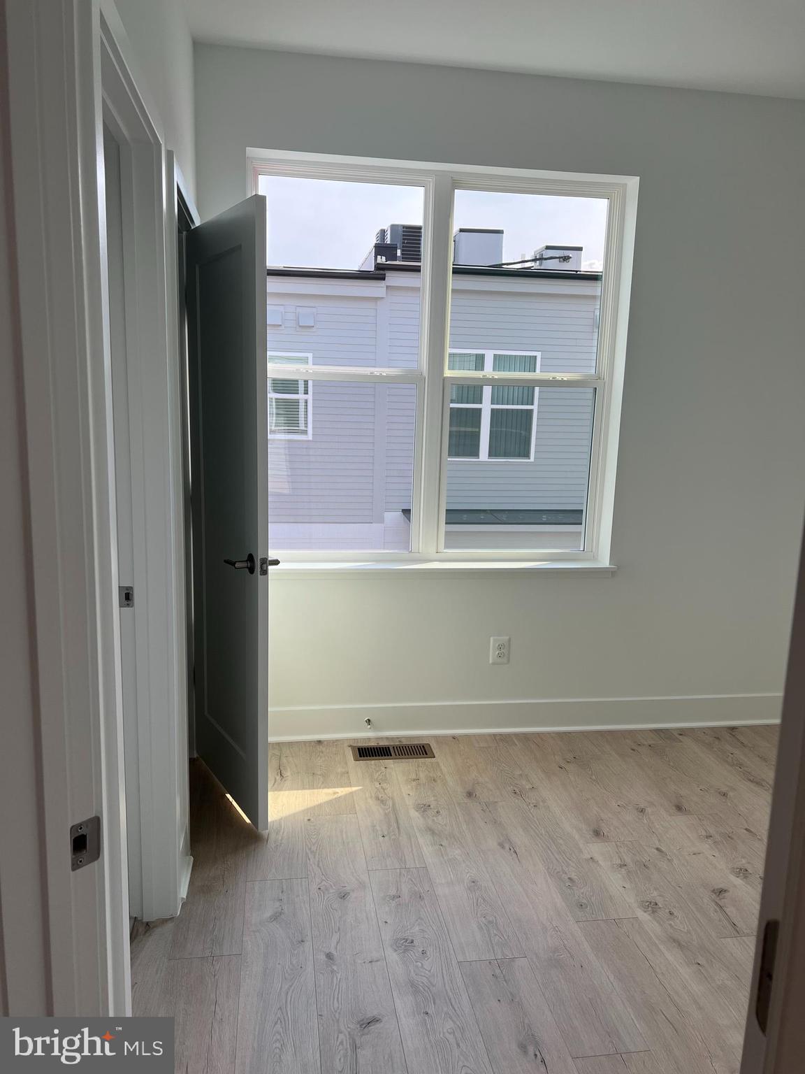 2139 Tysons Ridgeline Road Falls Church, VA 22043 - Photo 16 of 25 wooden floor and window in an empty room