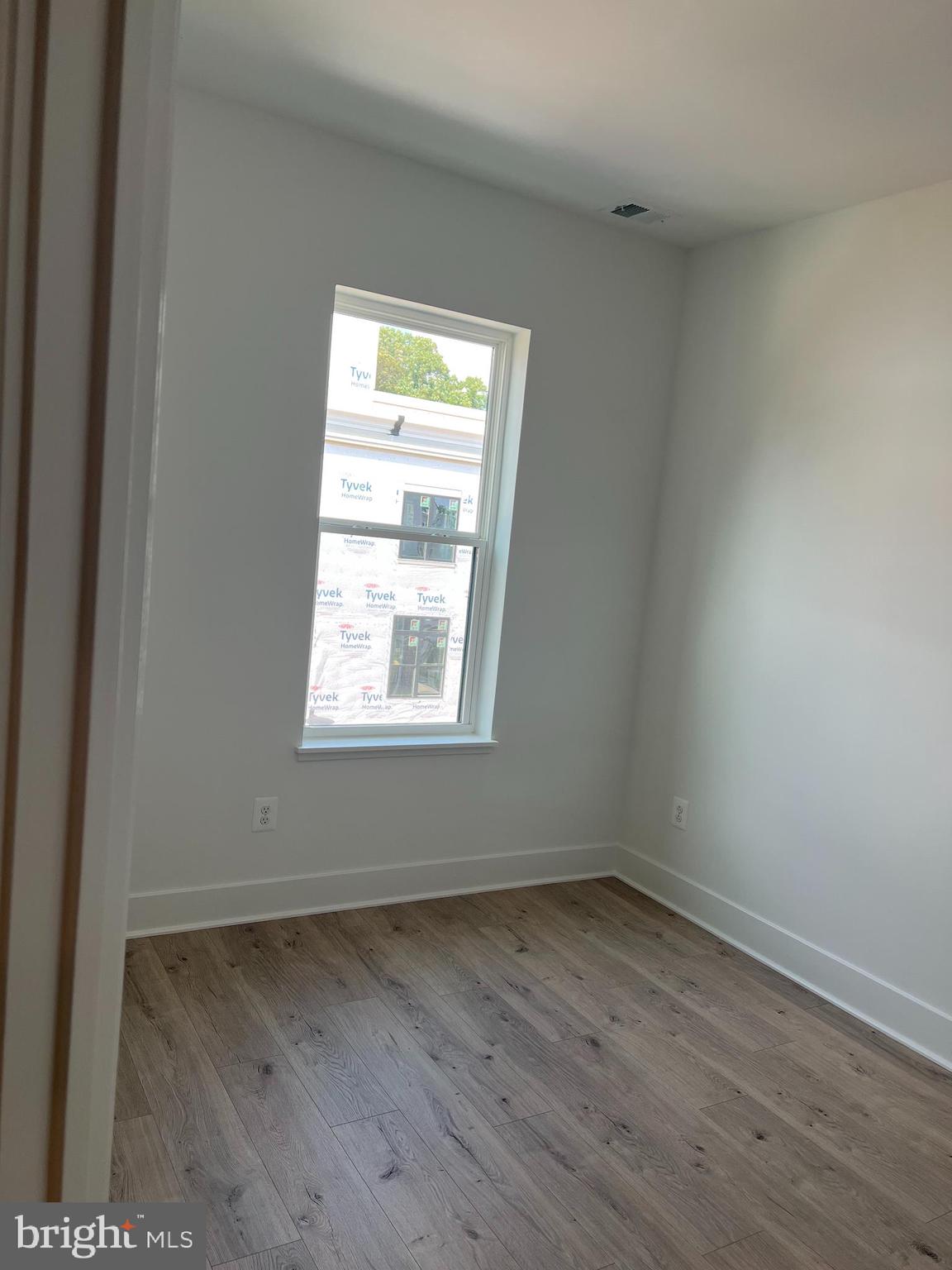 2139 Tysons Ridgeline Road Falls Church, VA 22043 - Photo 22 of 25 an empty room with wooden floor and windows