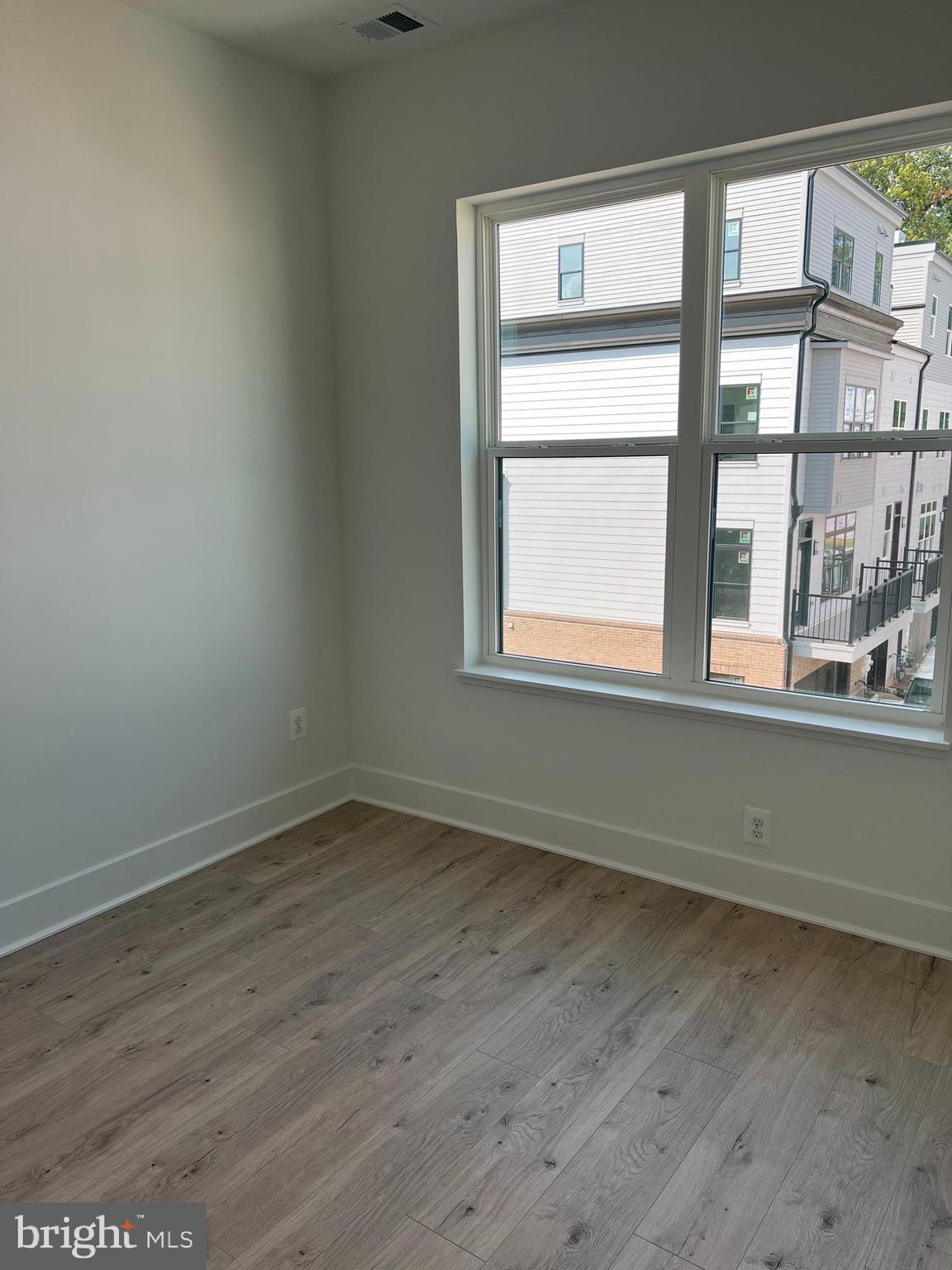 2139 Tysons Ridgeline Road Falls Church, VA 22043 - Photo 23 of 25 an empty room with wooden floor and windows