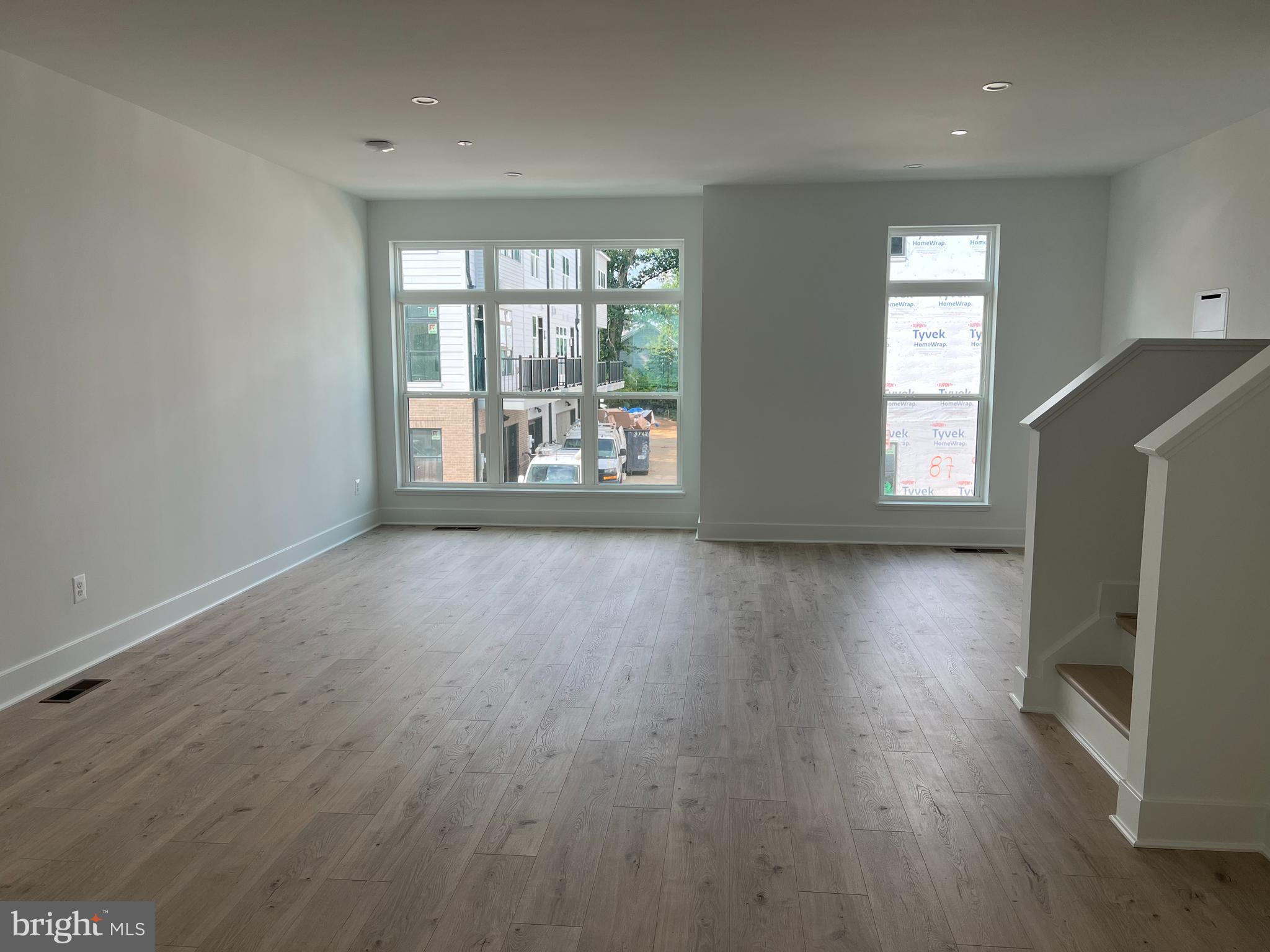 2139 Tysons Ridgeline Road Falls Church, VA 22043 - Photo 7 of 25 an empty room with wooden floor and windows