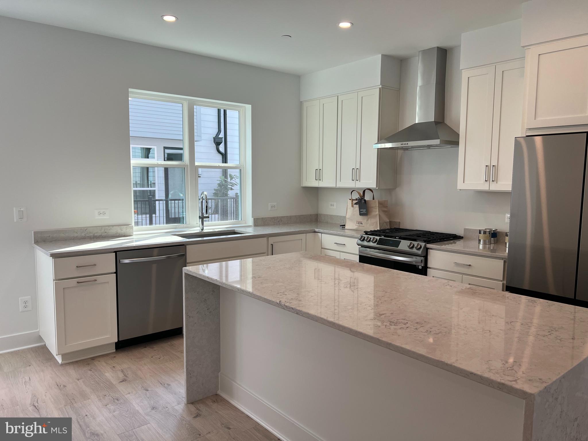 2139 Tysons Ridgeline Road Falls Church, VA 22043 - Photo 9 of 25 a kitchen with stainless steel appliances granite countertop a sink a stove and a refrigerator