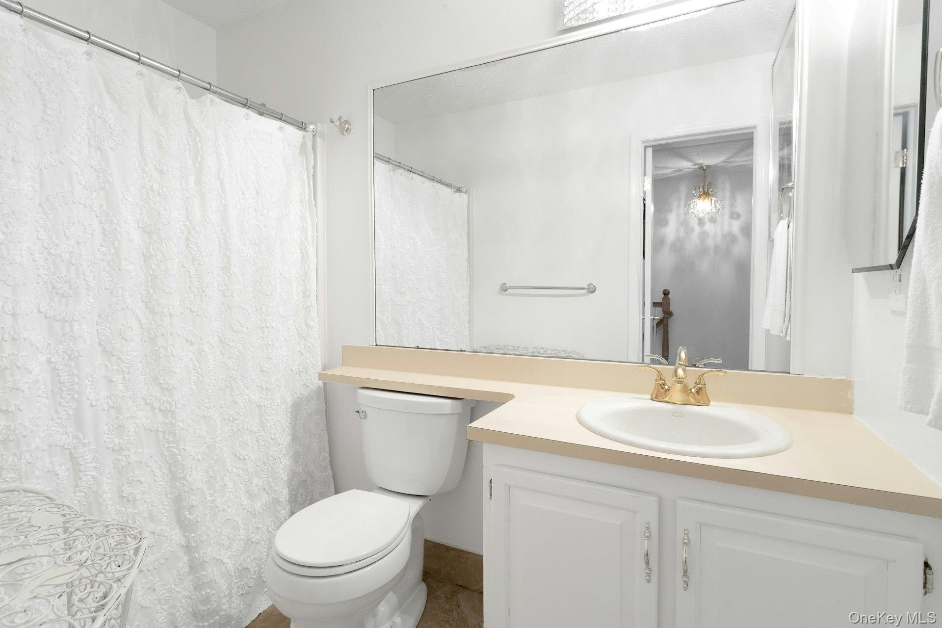 67 Winchester Avenue Peekskill, NY 10566 - Photo 19 of 26 a bathroom with a toilet a sink and a mirror