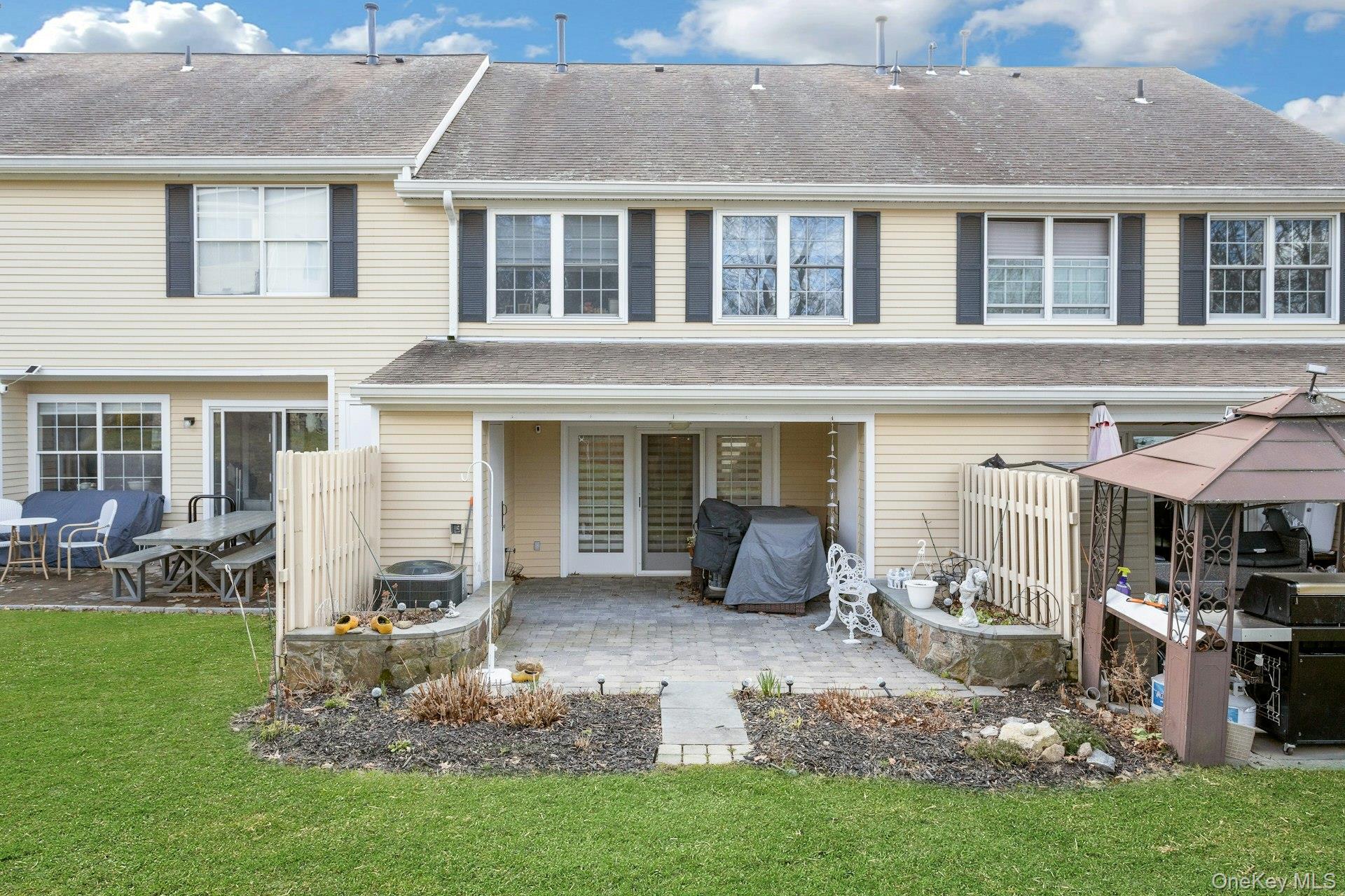 67 Winchester Avenue Peekskill, NY 10566 - Photo 20 of 26 a front view of a house with a garden and sitting area