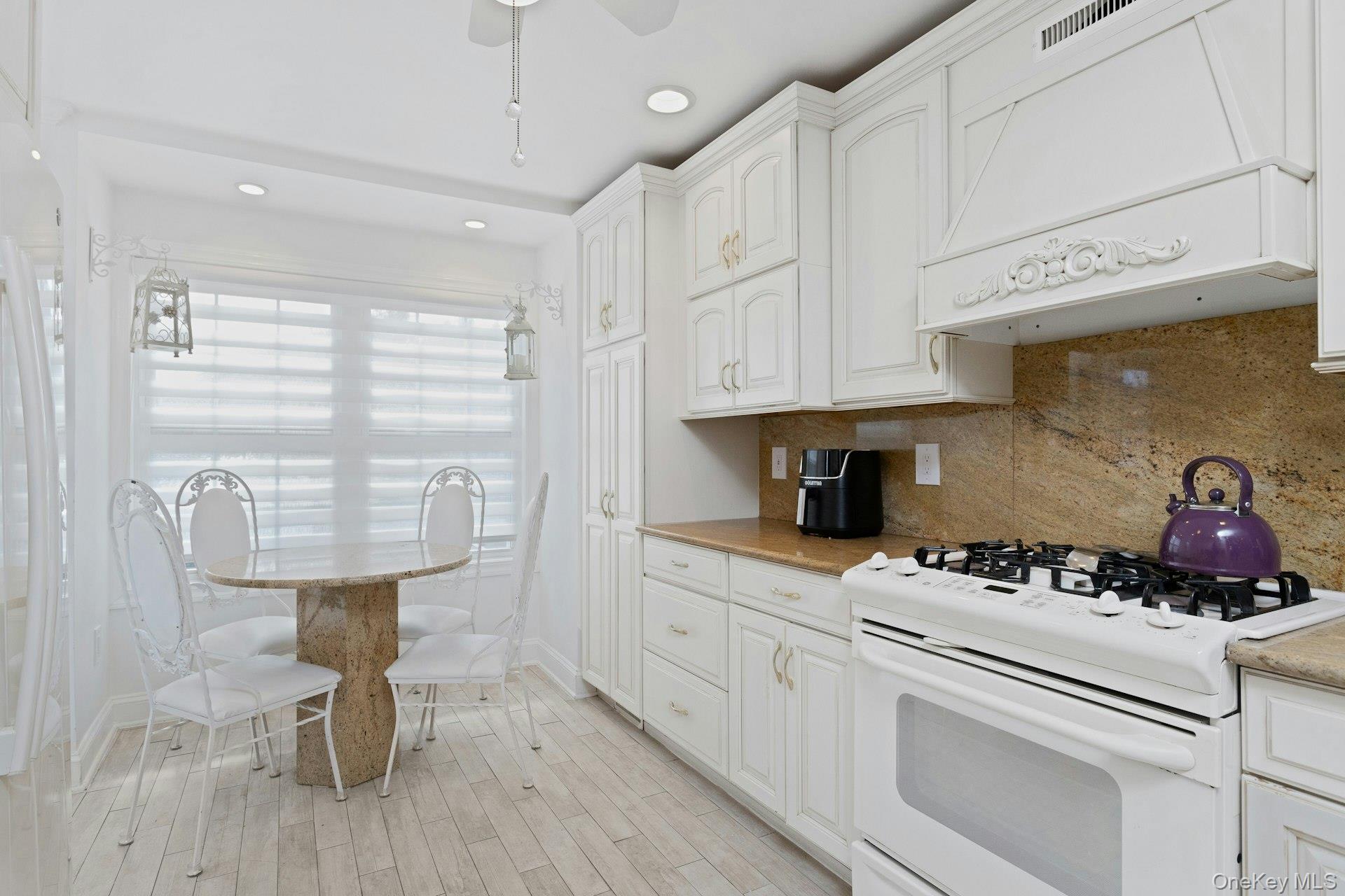 67 Winchester Avenue Peekskill, NY 10566 - Photo 8 of 26 a kitchen with stainless steel appliances a white cabinets and stove top oven