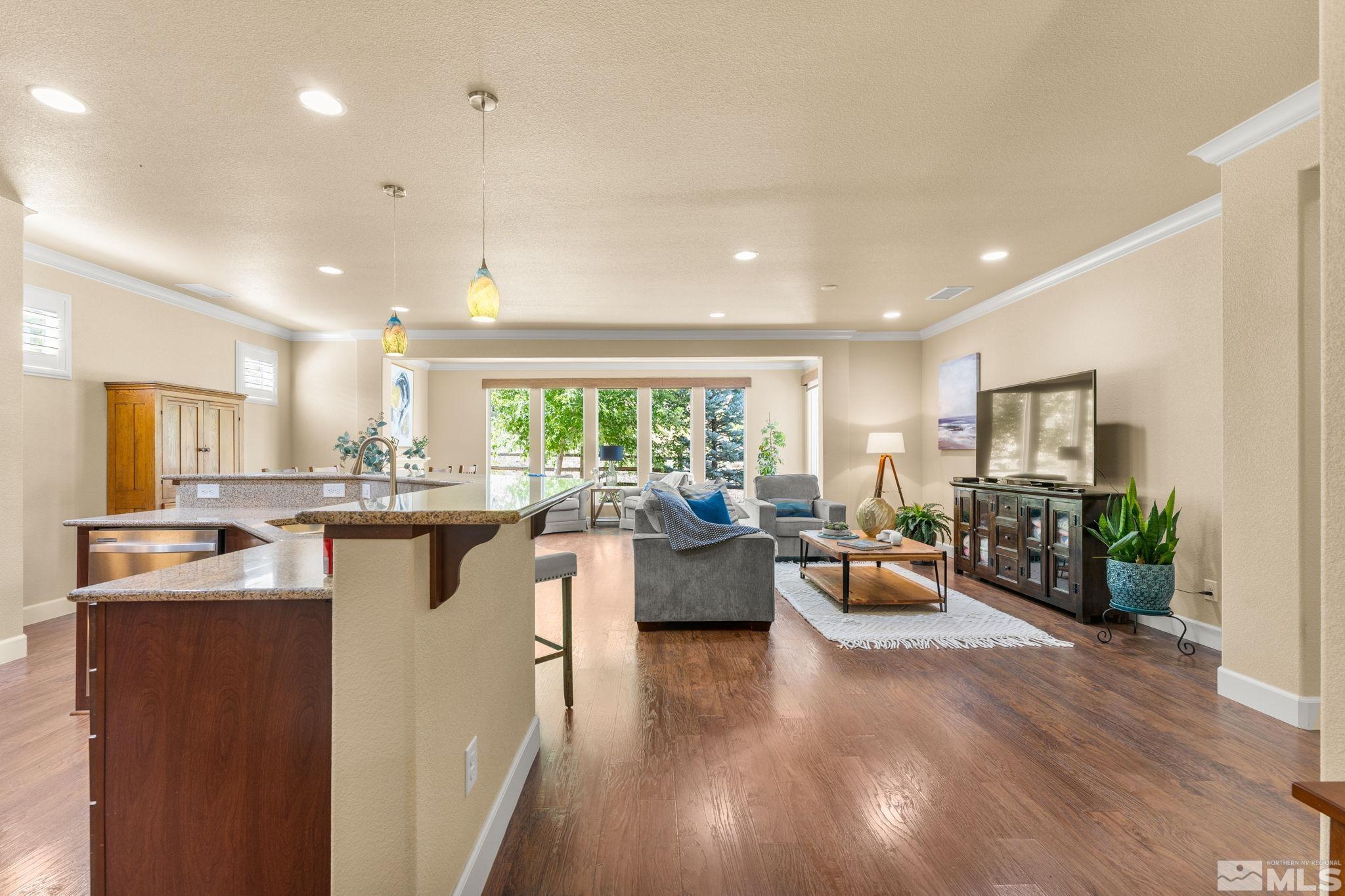 9207 Sassafras Trail Reno, NV 89523 - Photo 12 of 40 a living room with kitchen island furniture and a wooden floor