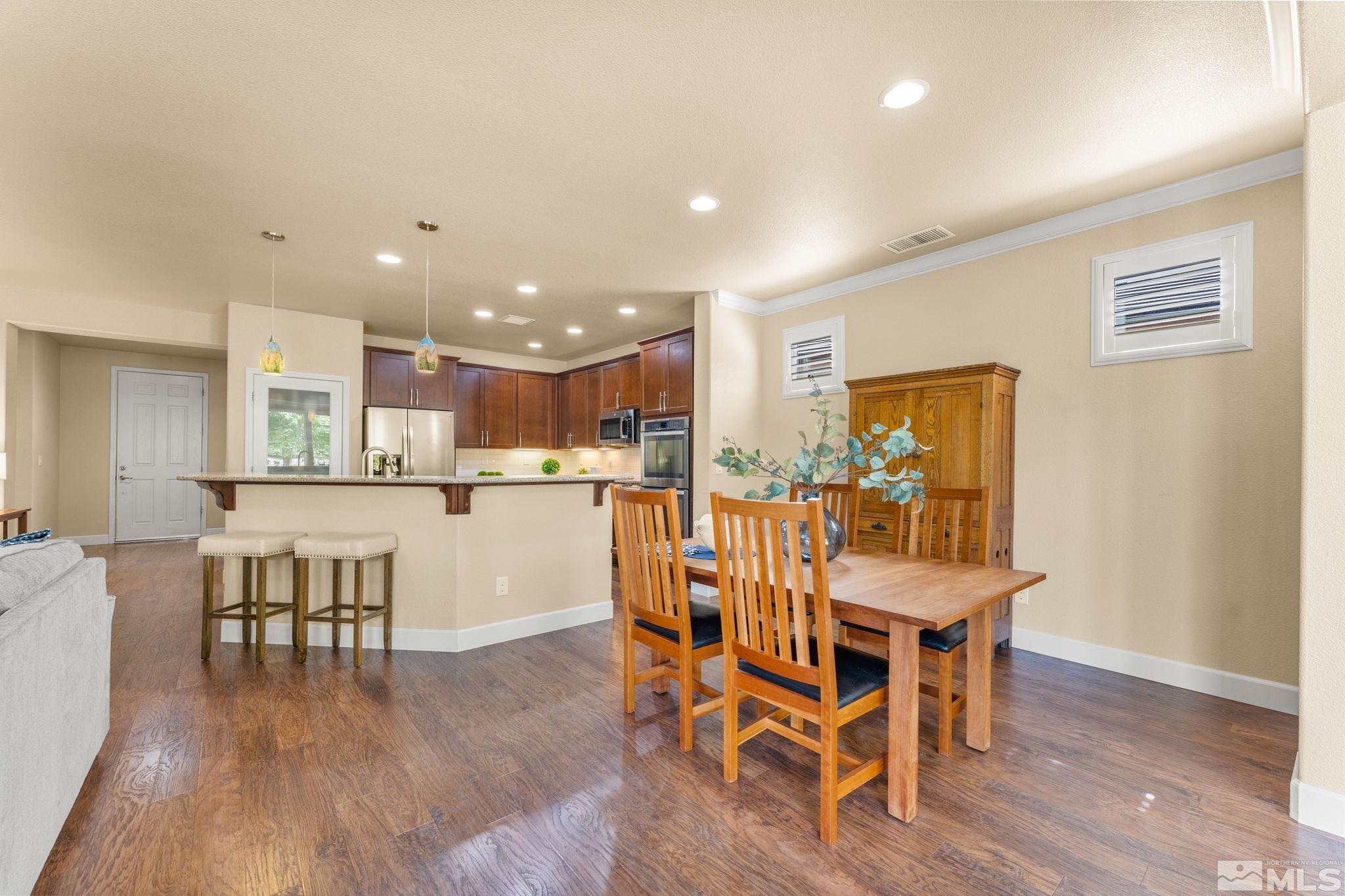9207 Sassafras Trail Reno, NV 89523 - Photo 18 of 40 a dining room with furniture and wooden floor