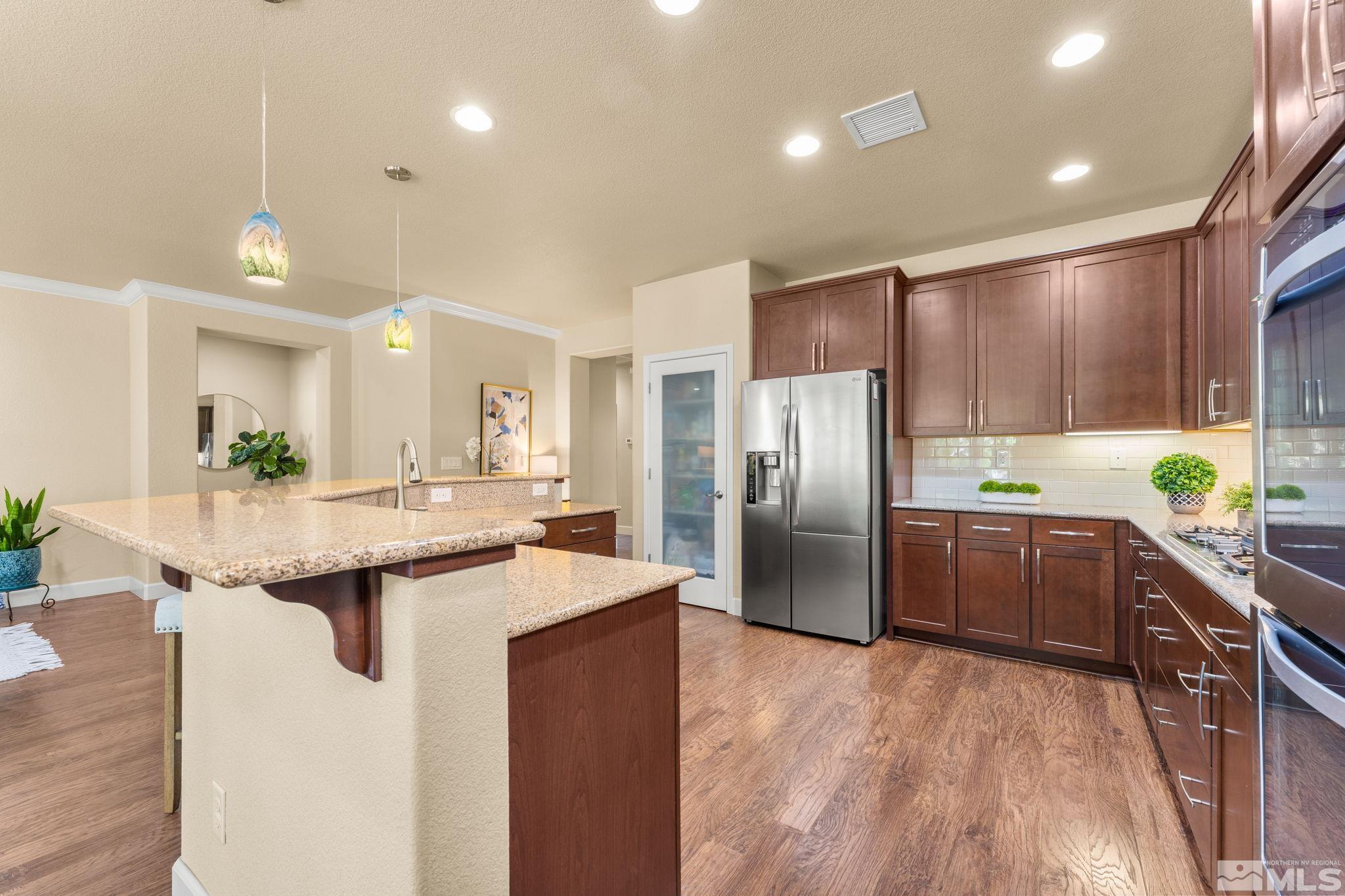 9207 Sassafras Trail Reno, NV 89523 - Photo 19 of 40 a kitchen with granite countertop a sink and stainless steel appliances