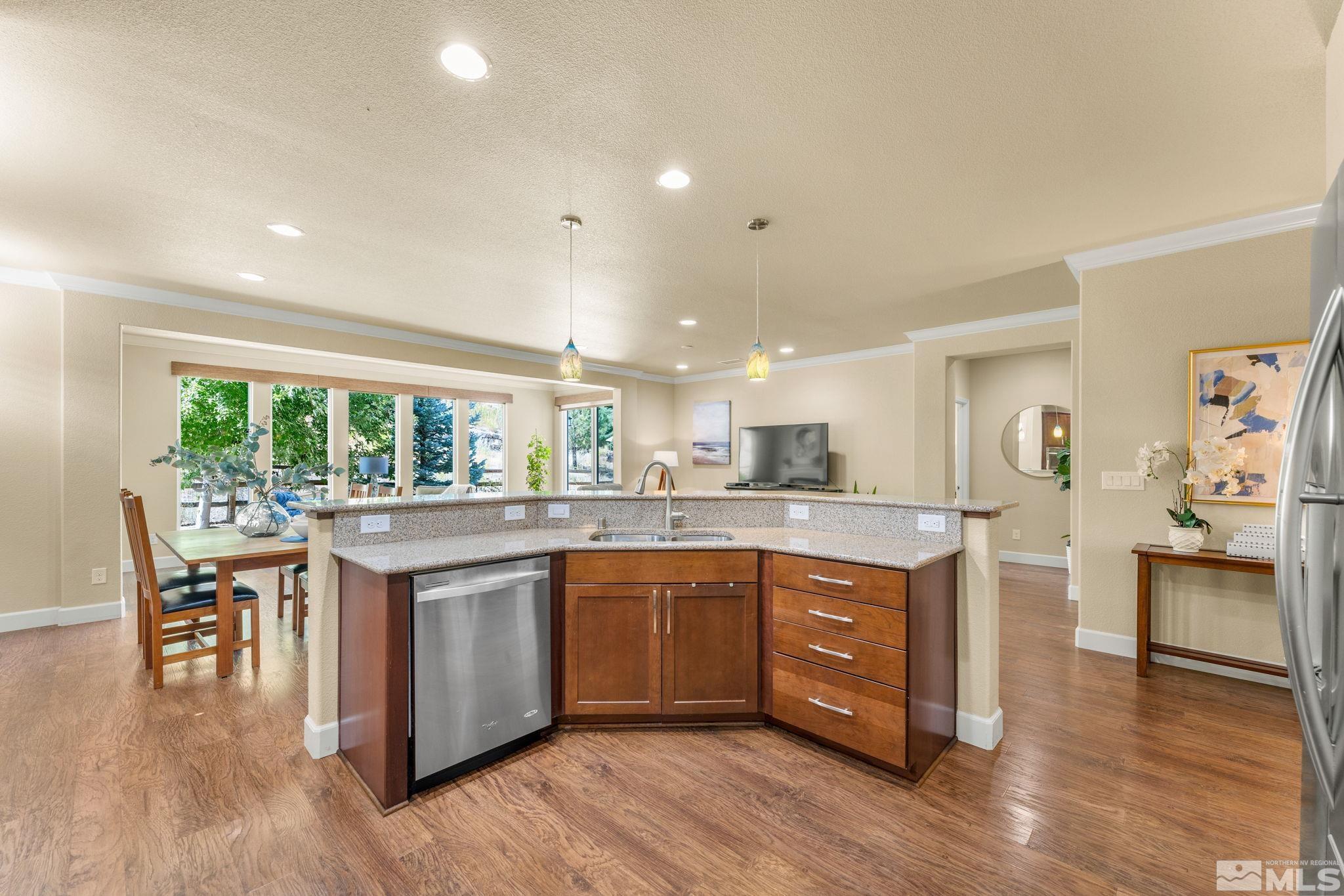 9207 Sassafras Trail Reno, NV 89523 - Photo 21 of 40 a kitchen with stainless steel appliances granite countertop wooden floors and sink