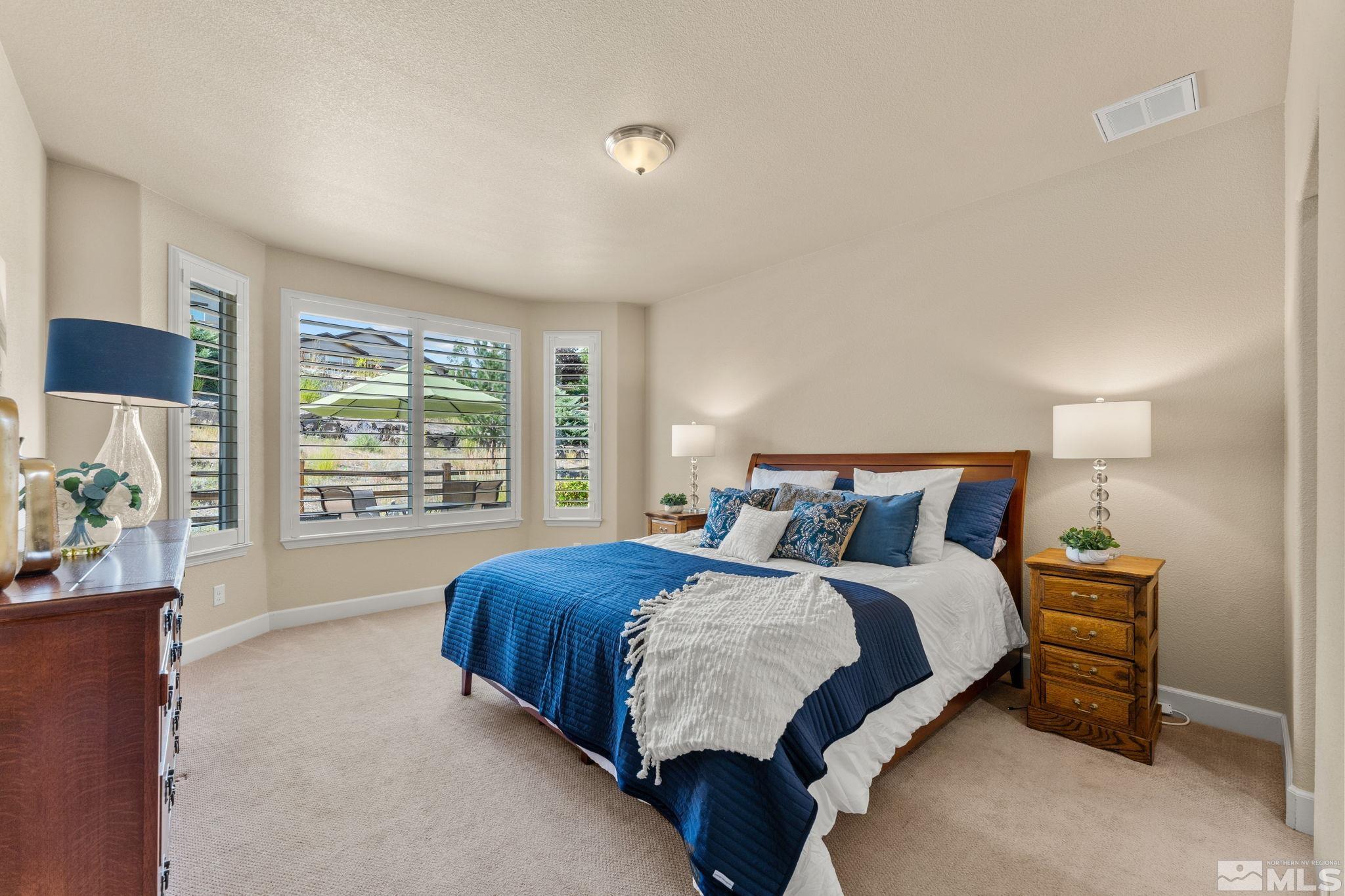 9207 Sassafras Trail Reno, NV 89523 - Photo 24 of 40 a bedroom with a bed and a window