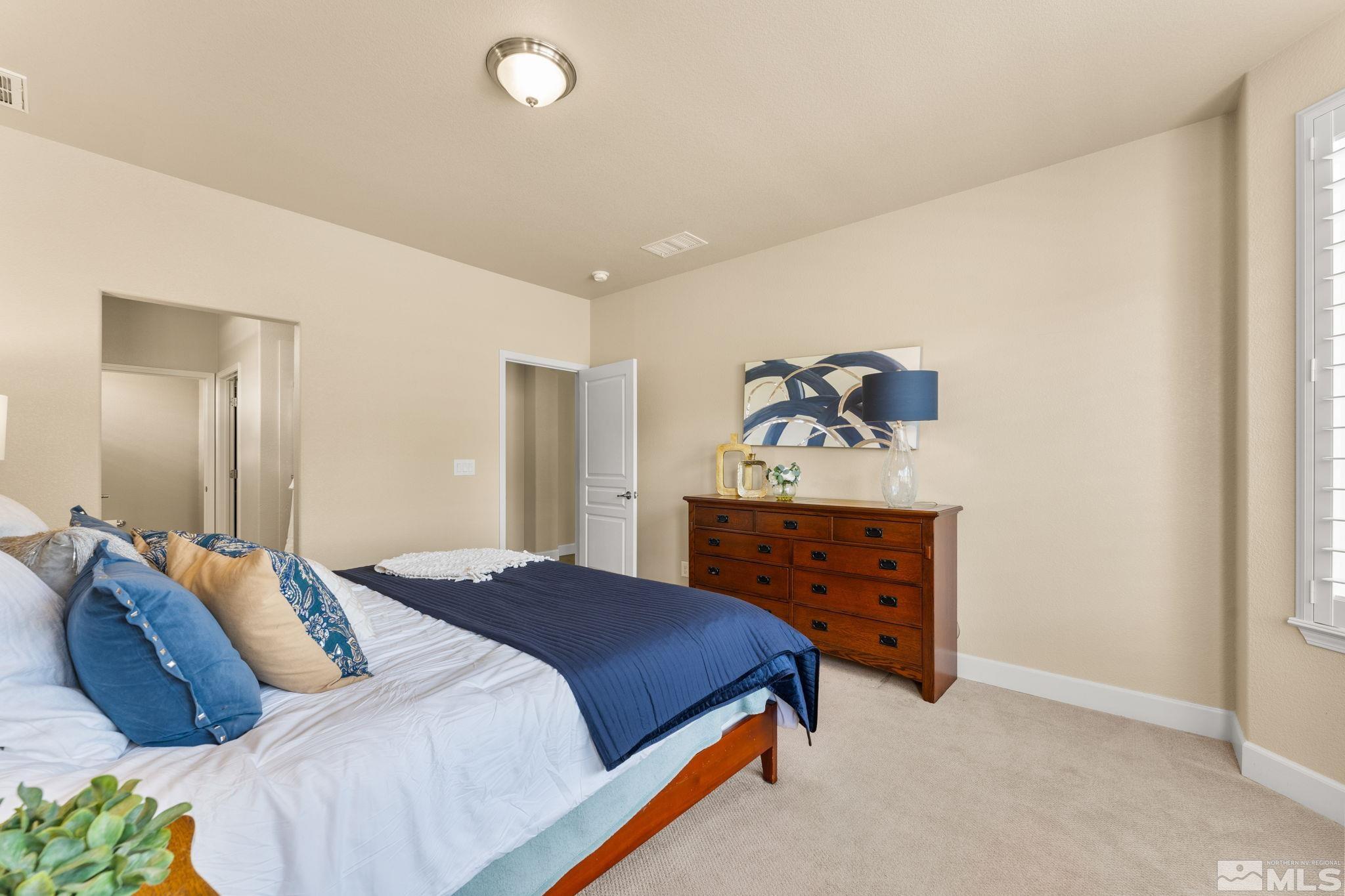 9207 Sassafras Trail Reno, NV 89523 - Photo 25 of 40 a bedroom with a bed and a dresser