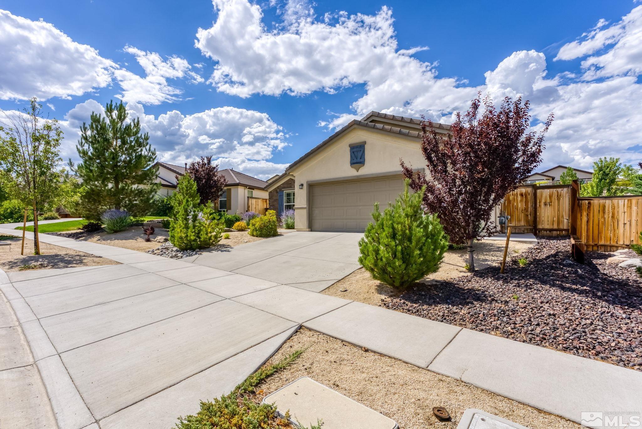9207 Sassafras Trail Reno, NV 89523 - Photo 3 of 40 a front view of a house with garden