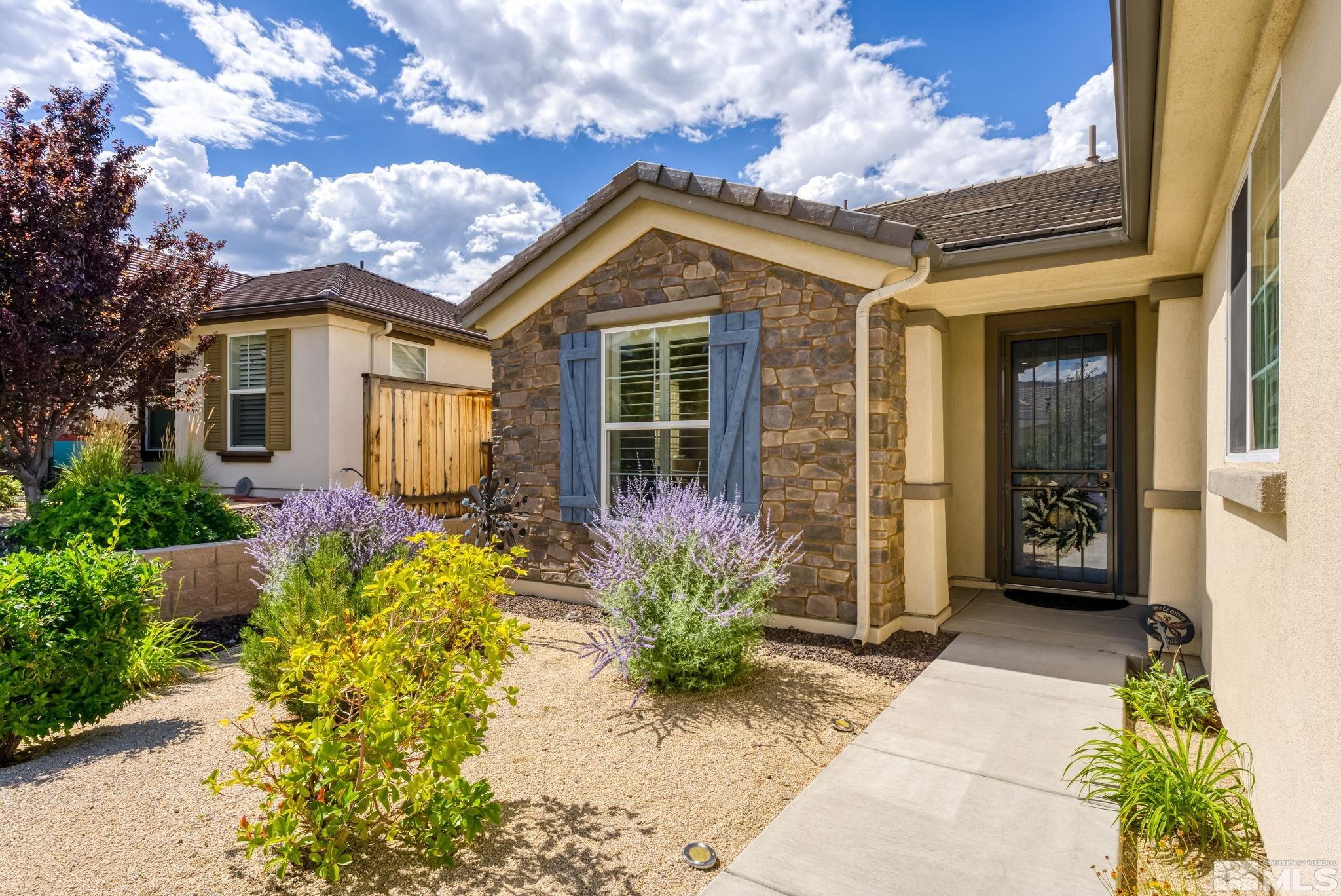 9207 Sassafras Trail Reno, NV 89523 - Photo 4 of 40 a front view of a house with a yard