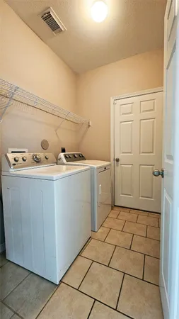 a utility room with a sink washer and dryer