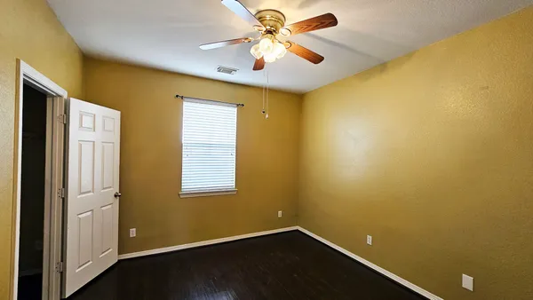 a view of a livingroom with a ceiling fan and a window
