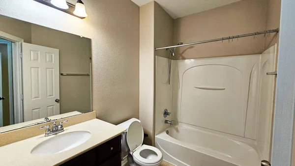 a bathroom with a sink toilet tub and shower