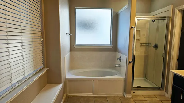 a bathroom with bathtub and a shower