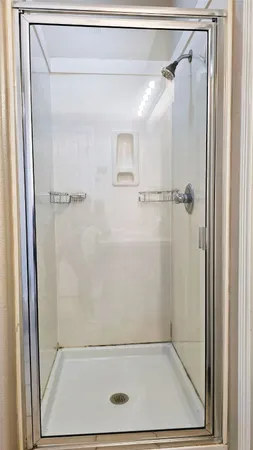 a bathroom with a glass shower door
