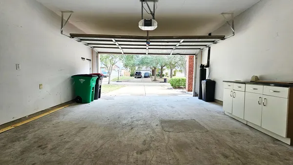 a big room with chandelier and windows