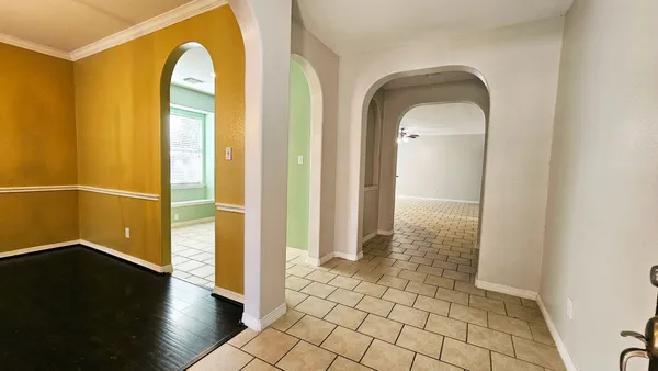 a view of a hallway with wooden floor
