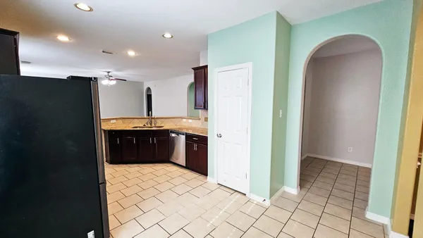 a kitchen with stainless steel appliances a refrigerator and a stove