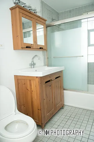 a bathroom with a sink a toilet and mirror