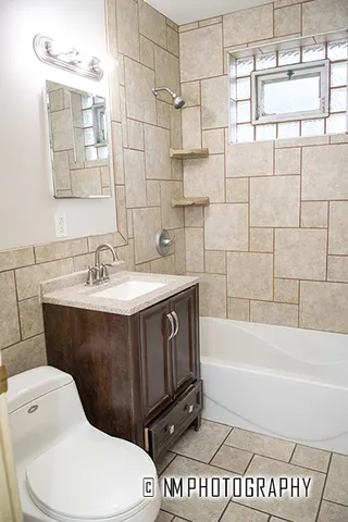 a bathroom with a sink a toilet and bathtub
