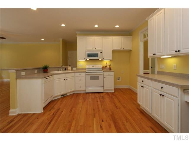 6909 Pinnacle Ridge Road Raleigh, NC 27603 - Photo 10 of 25 Kitchen has lots of solid surface counter top space & a planning desk. Kitchen