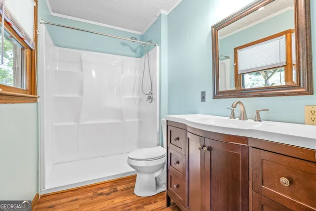 a view of a chair and table in backyard of the house