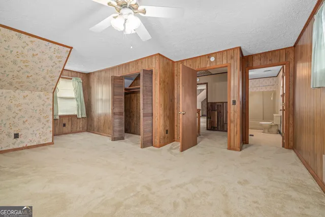 a view of a room with wooden floor and a window