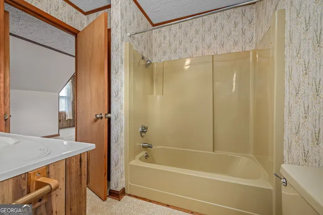 a kitchen with stainless steel appliances granite countertop a stove and cabinets