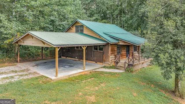 a view of an empty room with a fireplace and a window