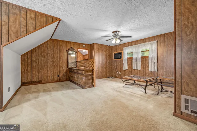a view of a hallway with wooden walls