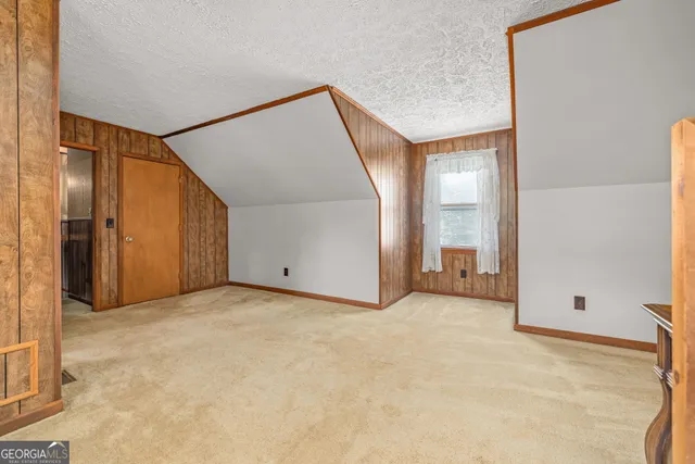 a bedroom with a bed and a chandelier fan