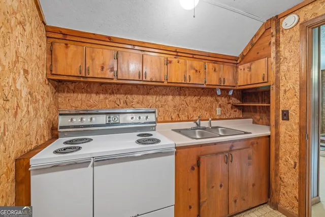 a bathroom with a granite countertop sink and a toilet