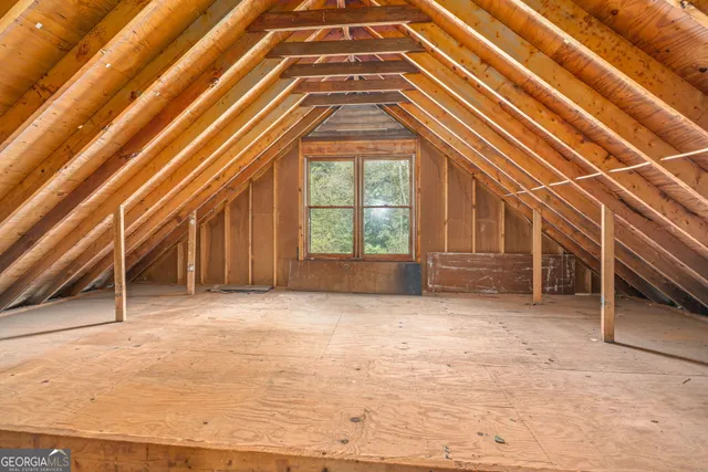 a view of a hallway with wooden floor and closet area