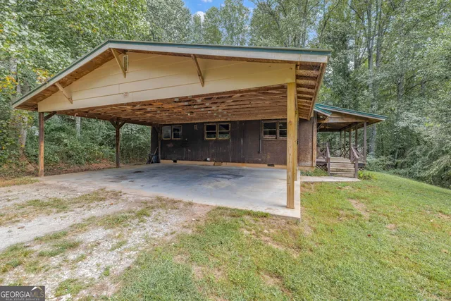 an aerial view of residential houses with outdoor space and trees