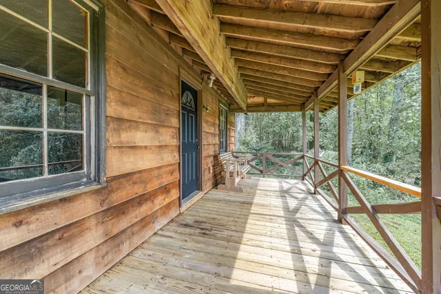 an aerial view of a house with a yard and outdoor seating
