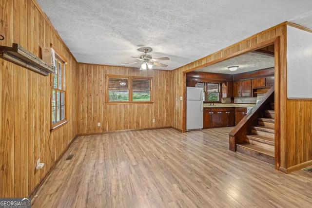 an aerial view of a house with a yard and lake view