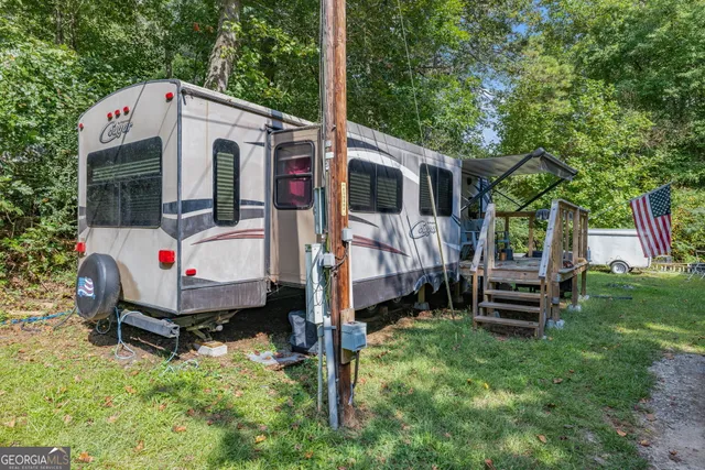 a large kitchen with stainless steel appliances granite countertop a refrigerator a stove and a sink with cabinets