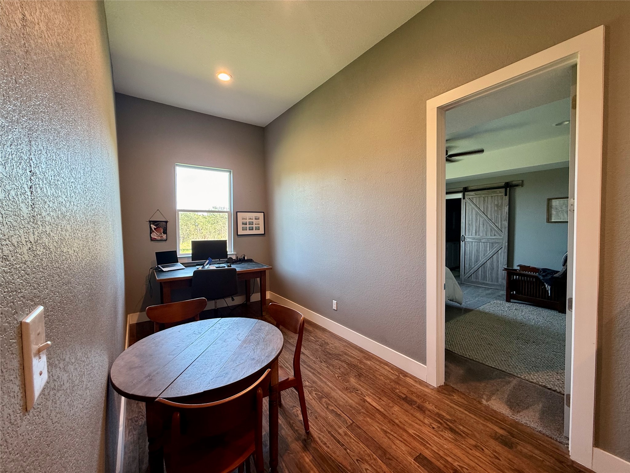 739 Pleasant Grove Road Elgin, TX 78621 - Photo 11 of 29 Dedicated area featuring wood-finish flooring, a bright window, recessed lighting, and a white trim door frame