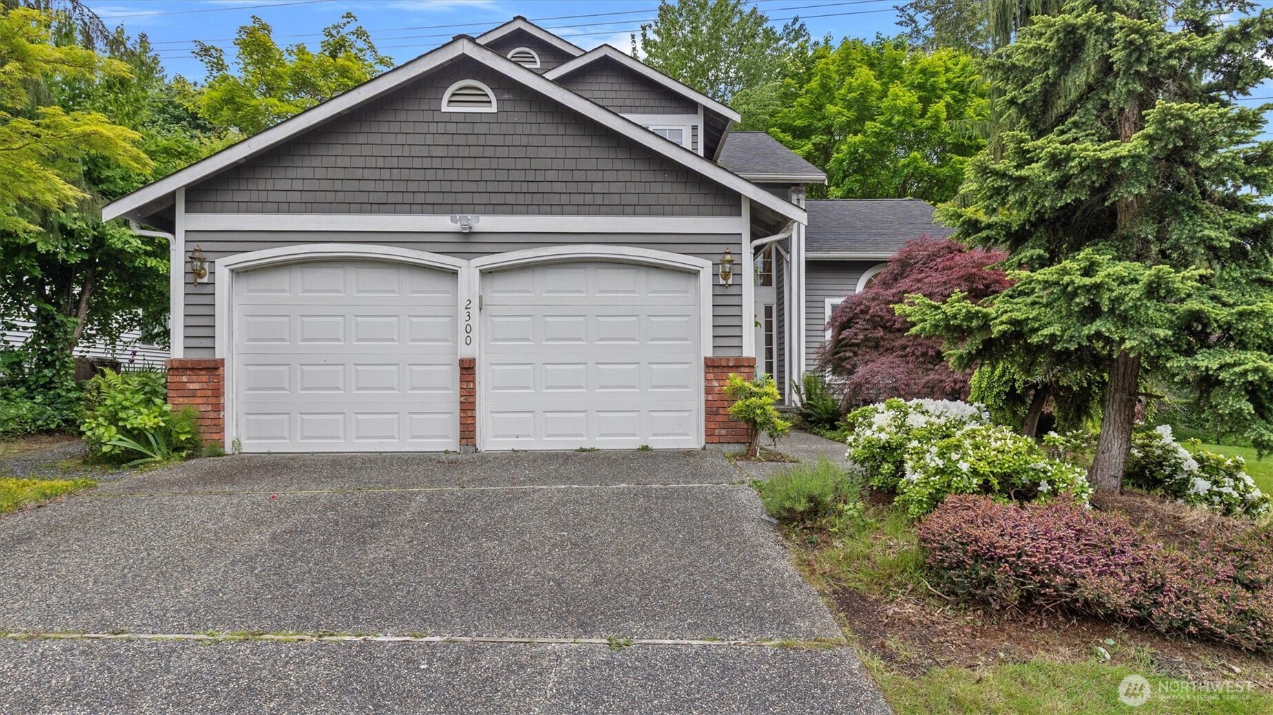 a view of a house with a yard and garage