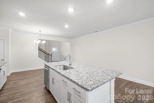 a kitchen with granite countertop a sink and dishwasher