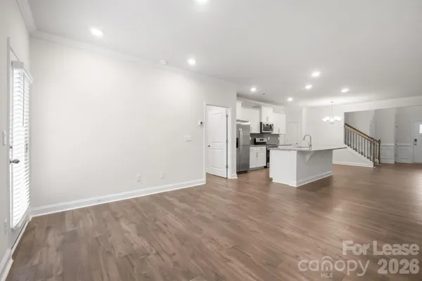 a view of kitchen with kitchen island and stainless steel appliances
