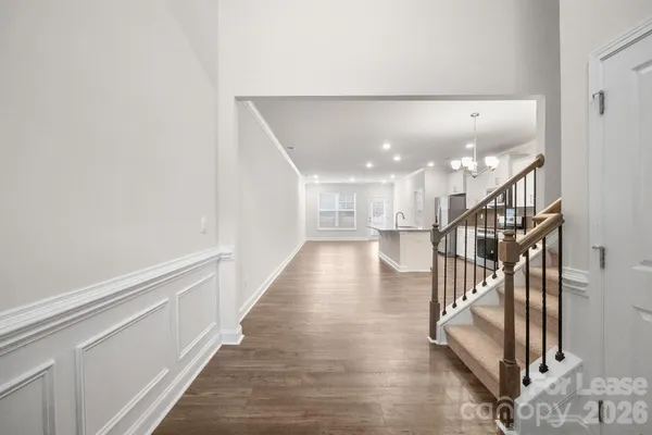 a view of entryway and hall with wooden floor