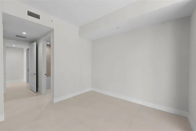 a projector room with furniture and a flat screen tv